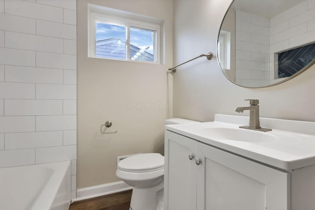 full bathroom with hardwood / wood-style floors, vanity, toilet, and tiled shower / bath combo