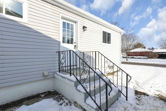 view of snow covered property entrance