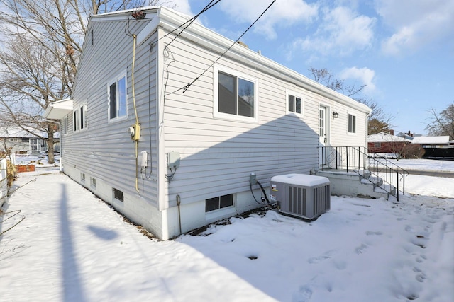 view of snowy exterior featuring cooling unit