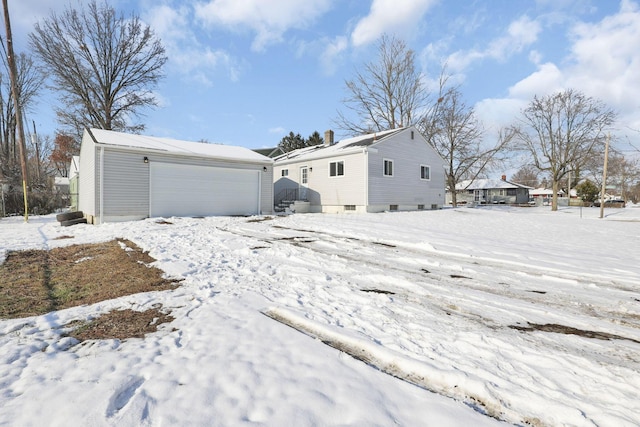 exterior space featuring a garage and an outdoor structure