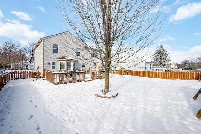 snow covered property featuring a wooden deck