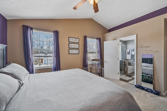 carpeted bedroom featuring a textured ceiling, connected bathroom, ceiling fan, and lofted ceiling