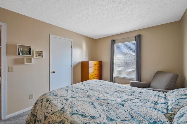 bedroom with carpet and a textured ceiling