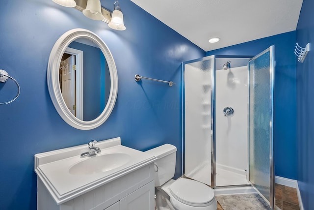 bathroom with vanity, toilet, and an enclosed shower