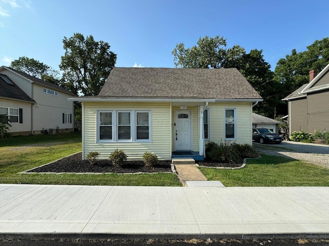 bungalow-style house with a front yard