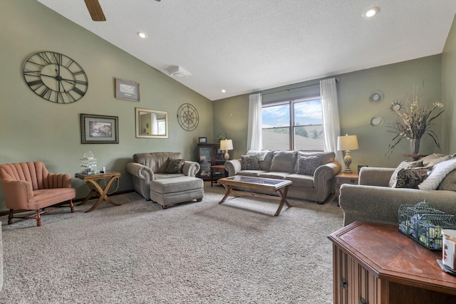 living room with carpet, a textured ceiling, ceiling fan, and lofted ceiling