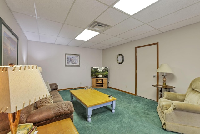 carpeted living room with a drop ceiling