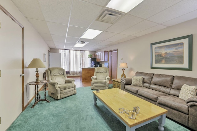 carpeted living room featuring a paneled ceiling