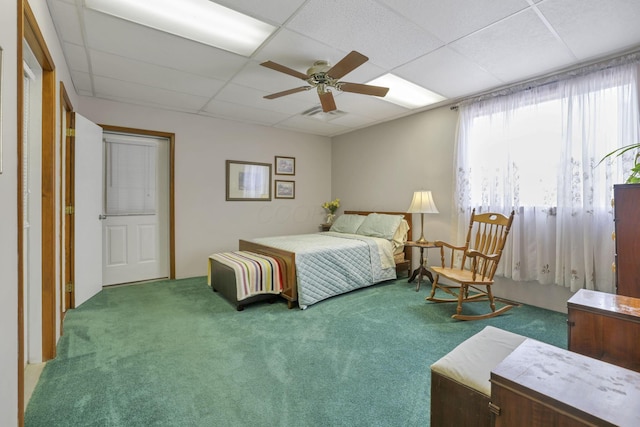 bedroom featuring a paneled ceiling, ceiling fan, and carpet flooring