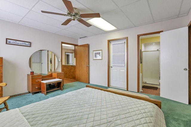 bedroom with carpet flooring, ceiling fan, a drop ceiling, and connected bathroom