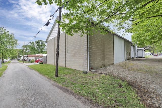 view of side of home featuring a garage and an outdoor structure