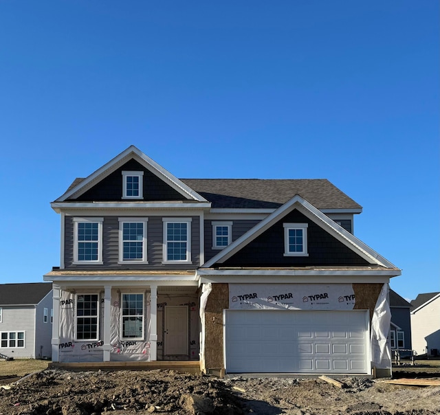 view of front facade with a garage and a porch