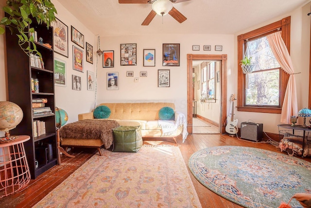 living area featuring ceiling fan and hardwood / wood-style flooring