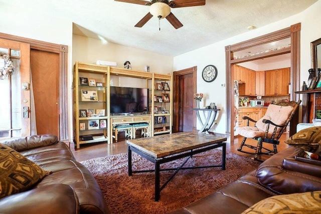 living room featuring a textured ceiling and ceiling fan