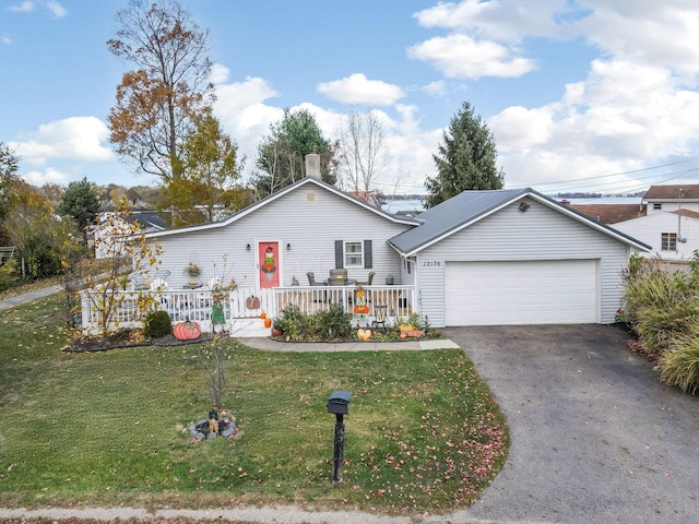 view of front of house featuring a front lawn, a porch, and a garage