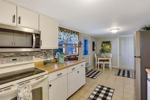 kitchen featuring light tile patterned floors, decorative backsplash, stainless steel appliances, and white cabinets