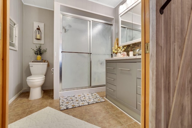 bathroom with tile patterned floors, toilet, an enclosed shower, crown molding, and vanity