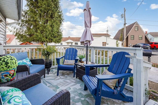 wooden terrace with an outdoor hangout area