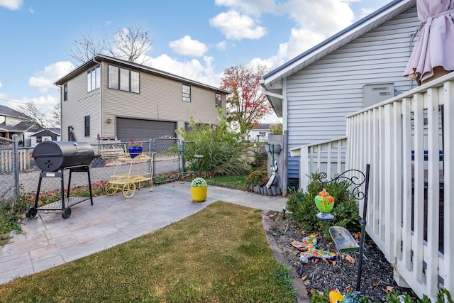 view of yard featuring a garage and a patio area