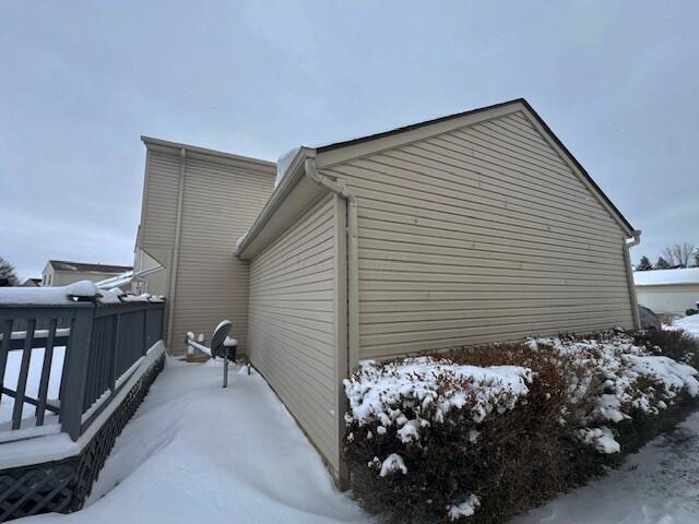 view of snow covered exterior featuring a deck