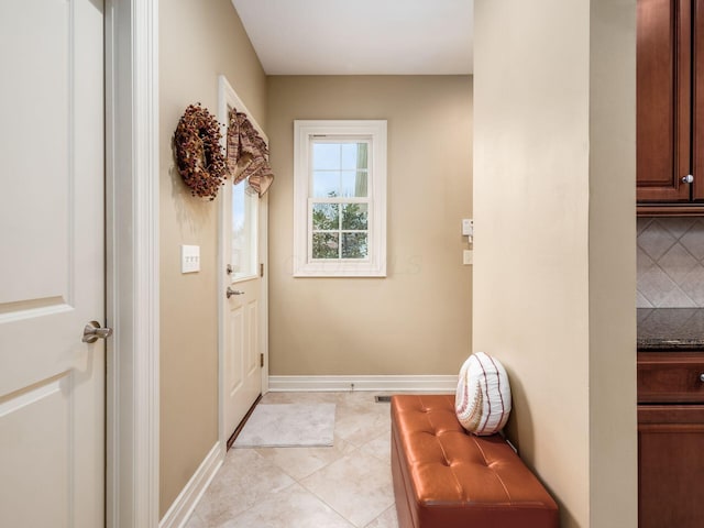 doorway with light tile patterned floors