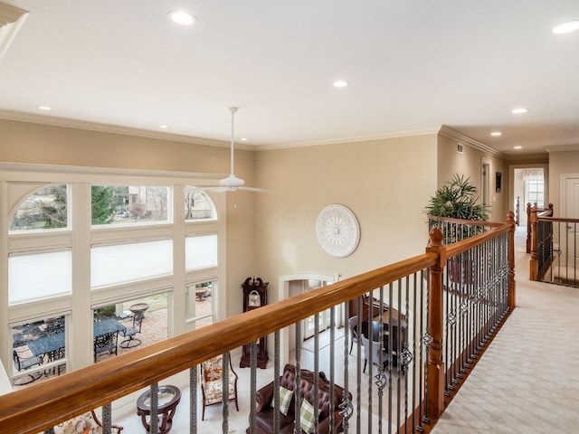 corridor with crown molding and carpet