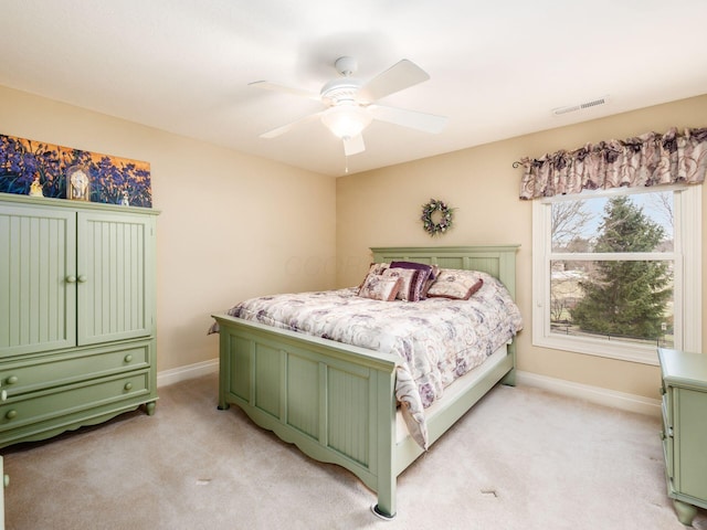 bedroom with ceiling fan and light carpet