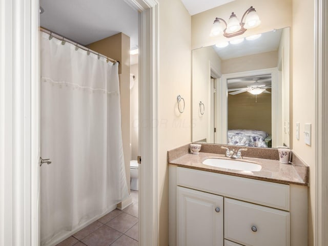 bathroom featuring vanity, ceiling fan, toilet, tile patterned floors, and a shower with shower curtain