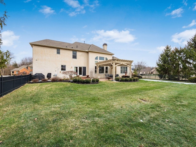 back of property featuring a yard and a pergola