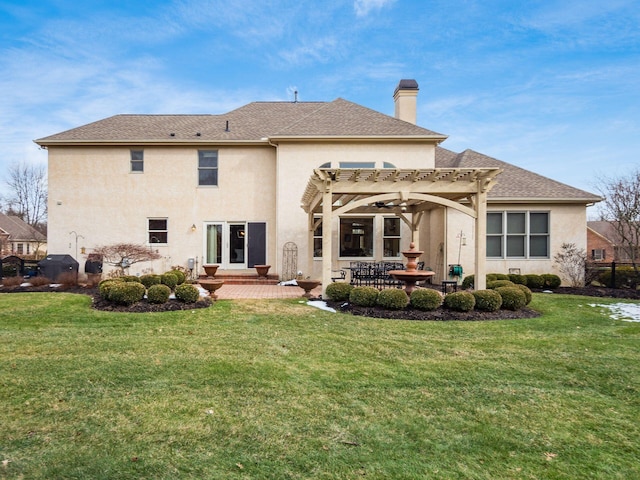 back of house featuring a yard, a pergola, and a patio area