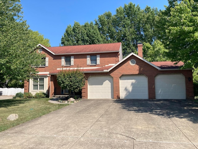 view of front of property featuring a front lawn and a garage