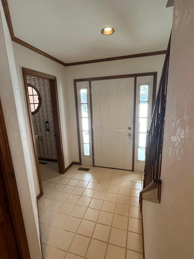 tiled entrance foyer with ornamental molding