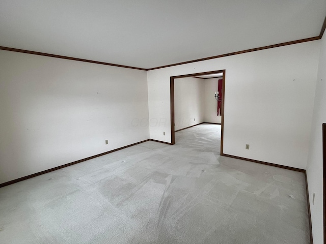 spare room featuring light colored carpet