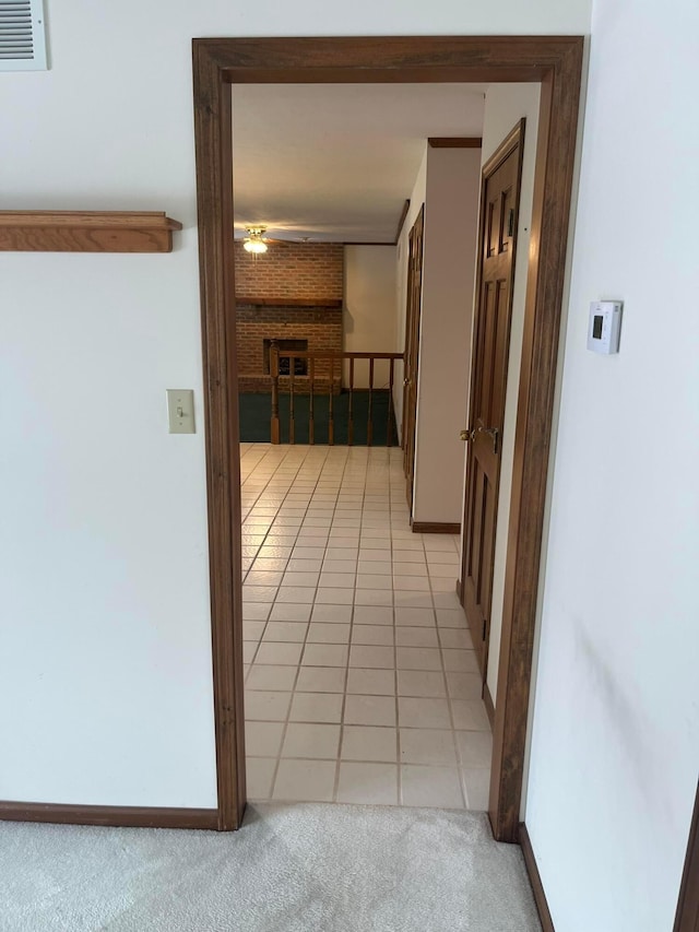 hall with light tile patterned floors