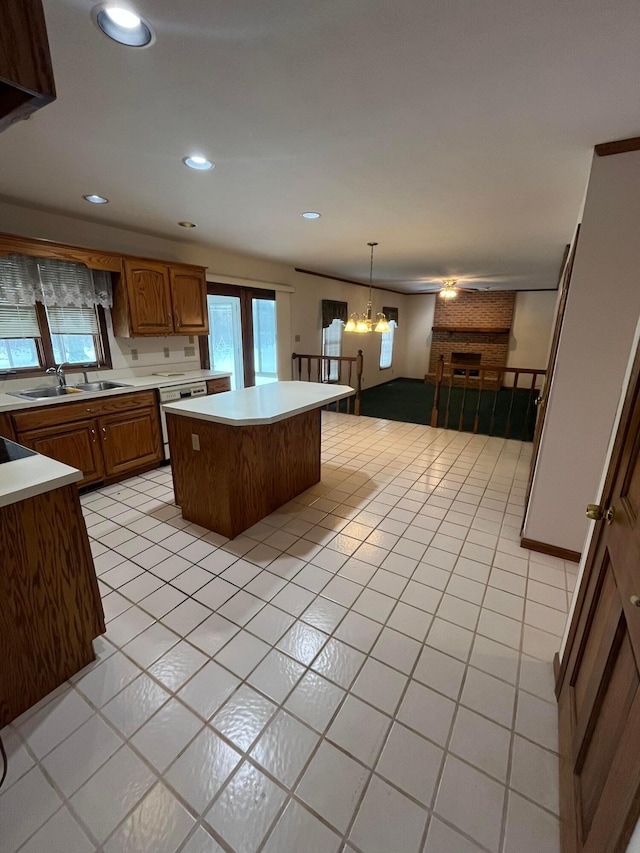 kitchen with pendant lighting, light tile patterned flooring, sink, a notable chandelier, and a kitchen island