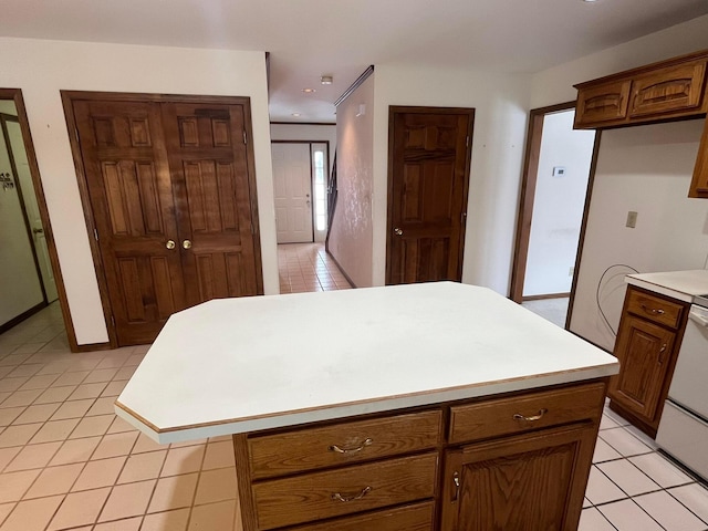 kitchen with light tile patterned floors, stove, and a kitchen island