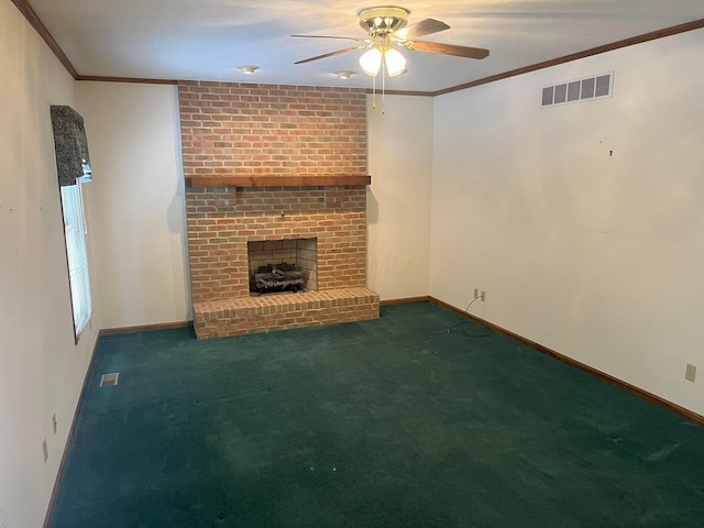 unfurnished living room featuring dark carpet, a brick fireplace, ceiling fan, and crown molding