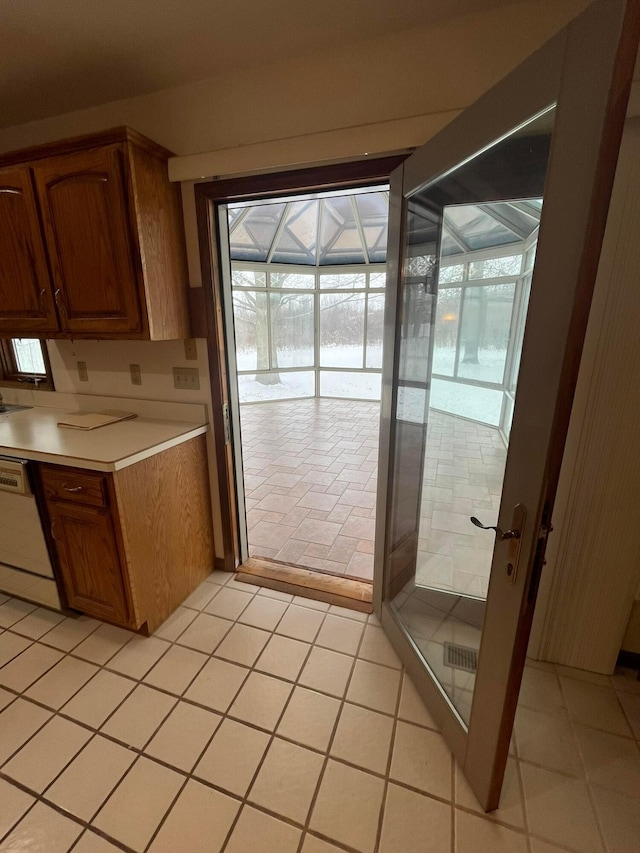 kitchen with dishwasher and light tile patterned floors