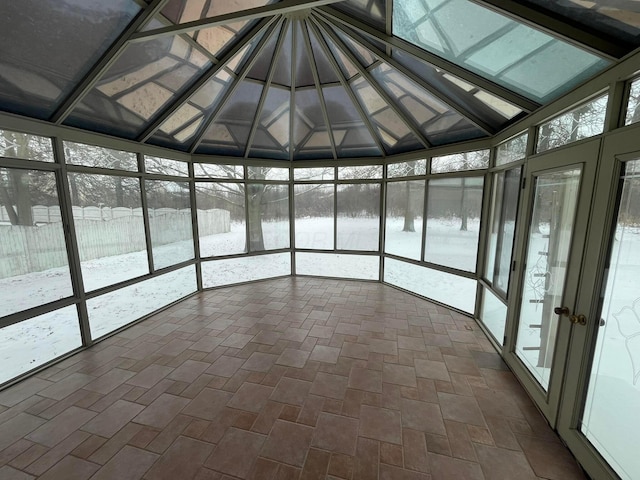 unfurnished sunroom with lofted ceiling