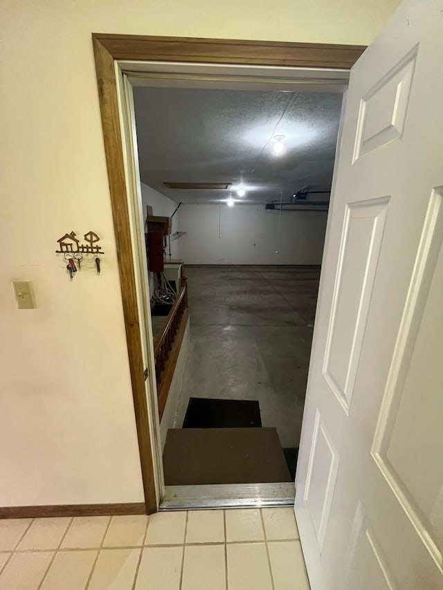 hall with light tile patterned floors