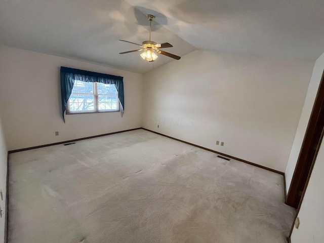 unfurnished room with light carpet, vaulted ceiling, and ceiling fan