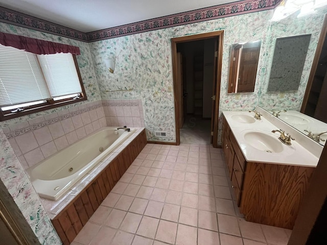 bathroom with tile patterned flooring, vanity, and a relaxing tiled tub