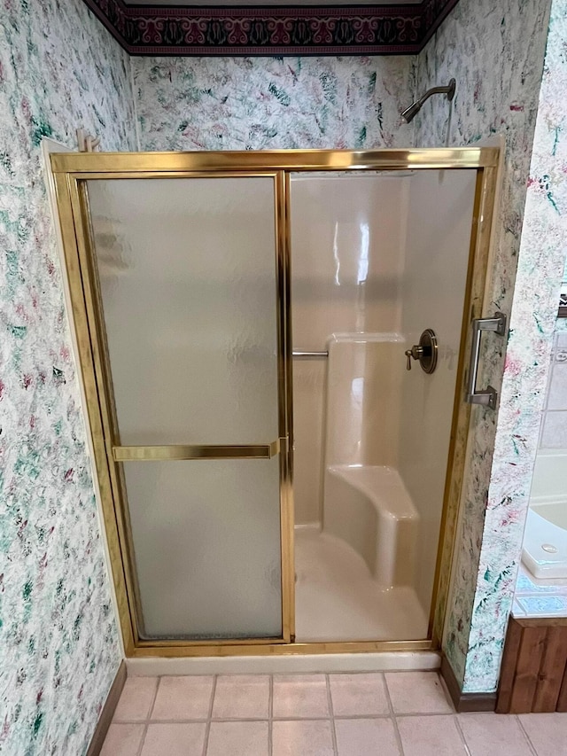 bathroom with tile patterned flooring and a shower with shower door