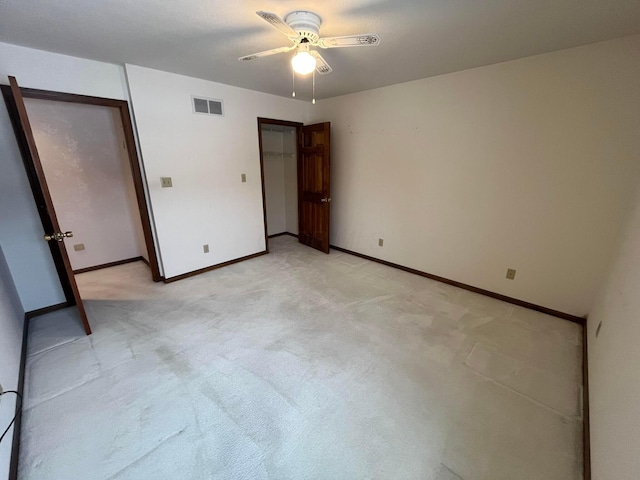 unfurnished bedroom featuring ceiling fan and light carpet