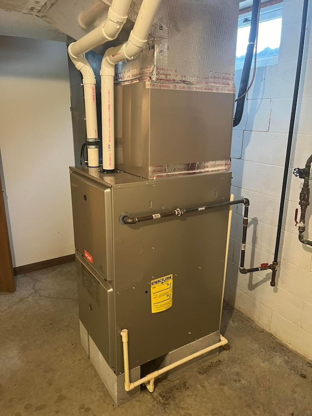 utility room featuring heating unit