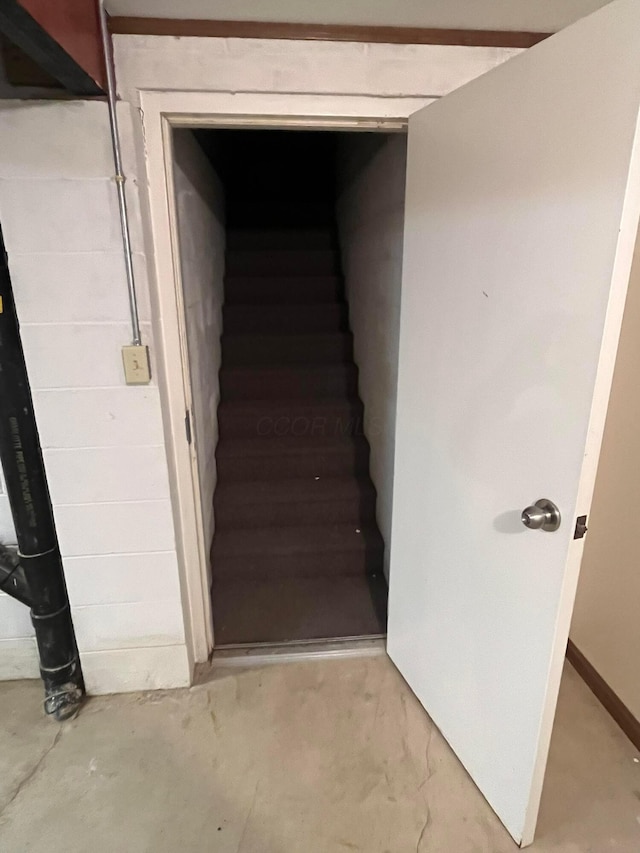 stairway with concrete flooring