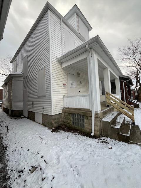 view of snow covered exterior with covered porch