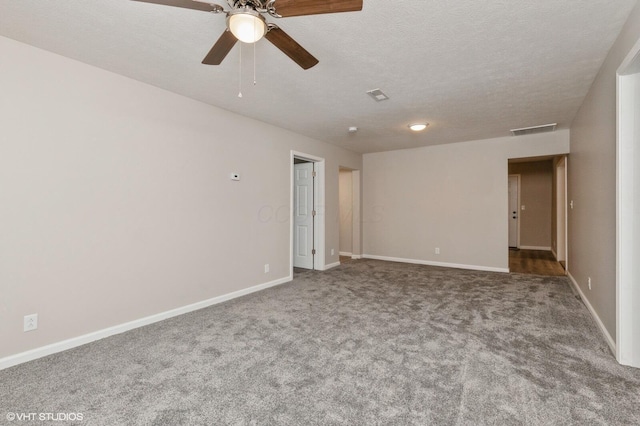 spare room featuring carpet flooring, ceiling fan, and a textured ceiling