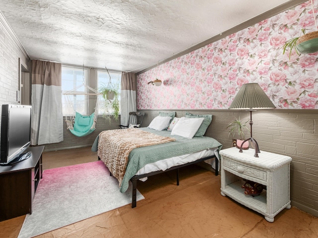 bedroom with a textured ceiling and ornamental molding