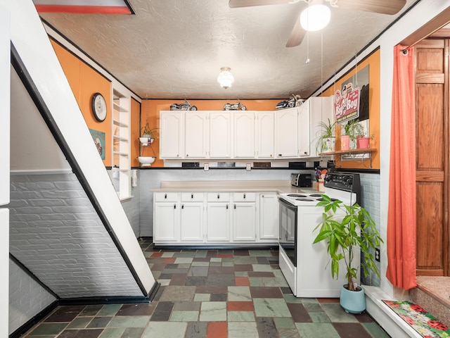 kitchen featuring ceiling fan, white cabinetry, and white electric range